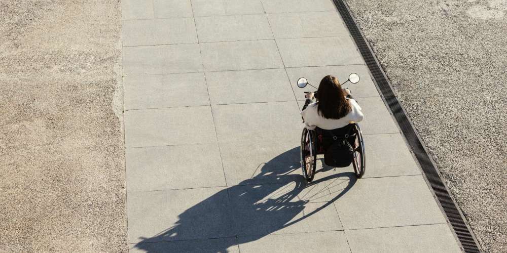 high-angle-of-woman-in-wheelchair-on-the-street high-angle-of-woman-in-wheelchair-on-the-street