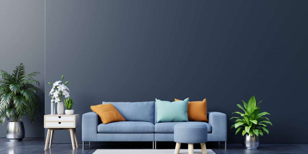 Modern living room interior with sofa and green plants,lamp,table on dark wall background. 3d rendering